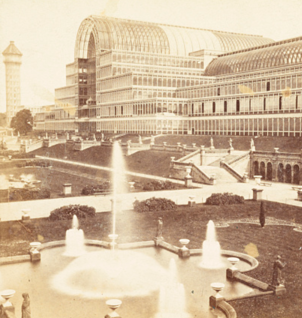 Sepia-toned image of the Crystal Palace, with a fountain in front. The building resembles a huge, multi-story greenhouse.
